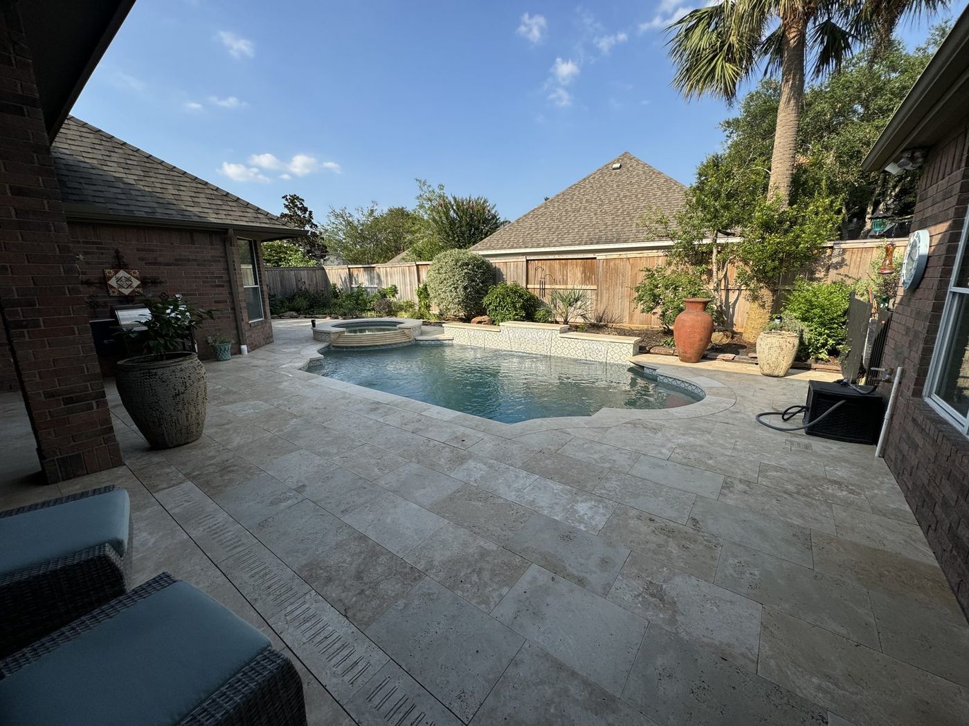 Wide view of travertine pool deck transformation
