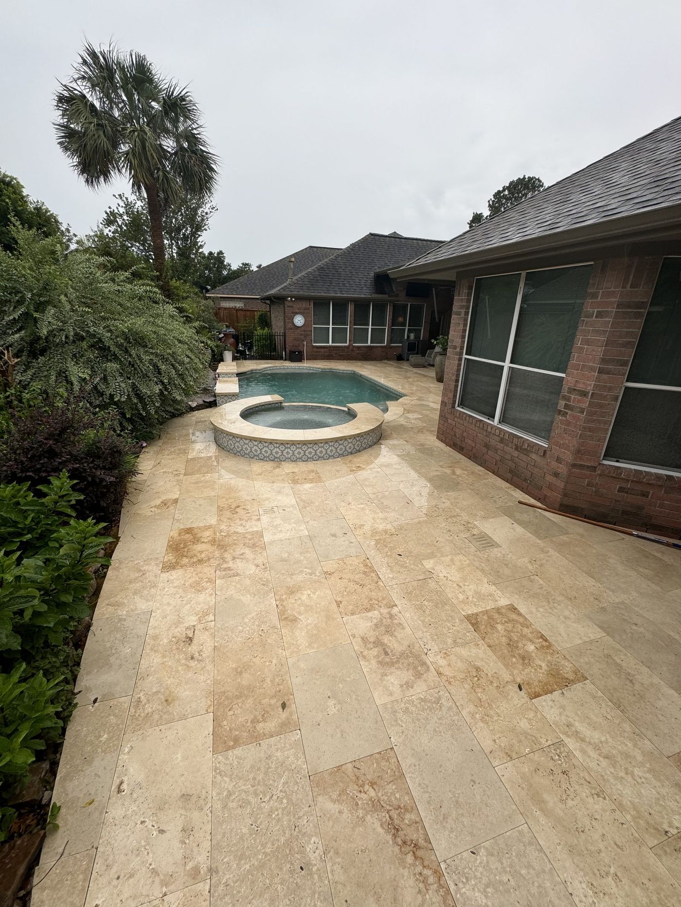 Travertine pool with raised wall and spa